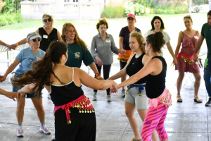 Circle-dance-cut-smile-shlicha-Alexis-Kayla-background